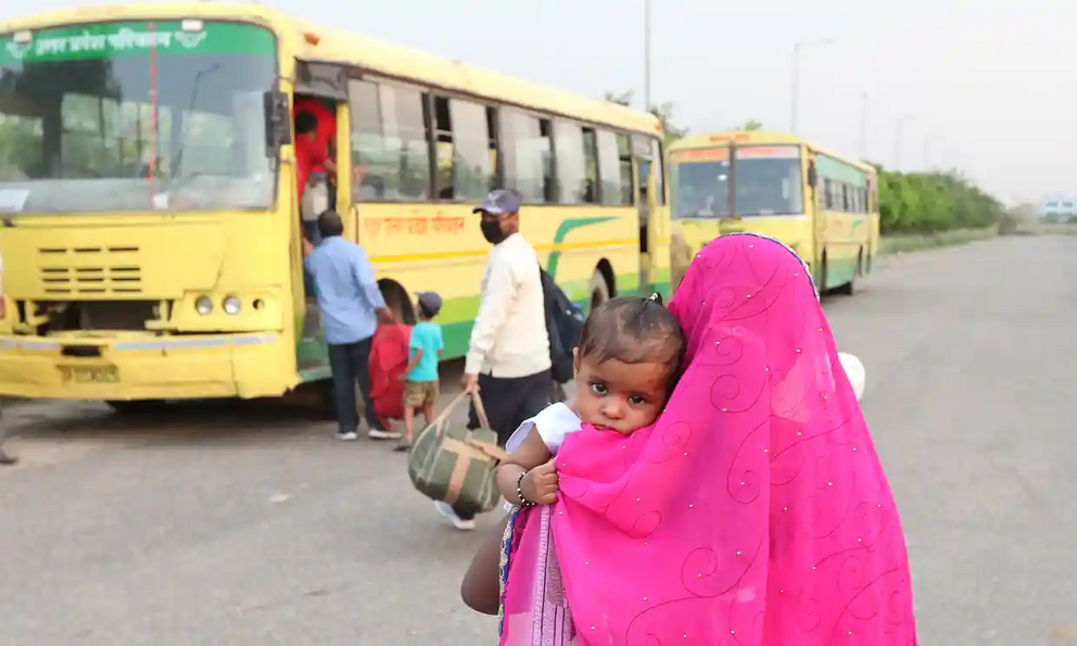 A bus for migrant workers stops to pick up passengers in Noida, south-east of New Delhi.