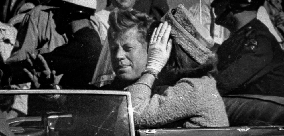 President John F. Kennedy, with his wife Jacqueline Kennedy seated beside him, waves from his motorcade minutes before he was shot in Dallas, Texas on Nov. 22, 1963. | Jim Altgens/AP Photo 