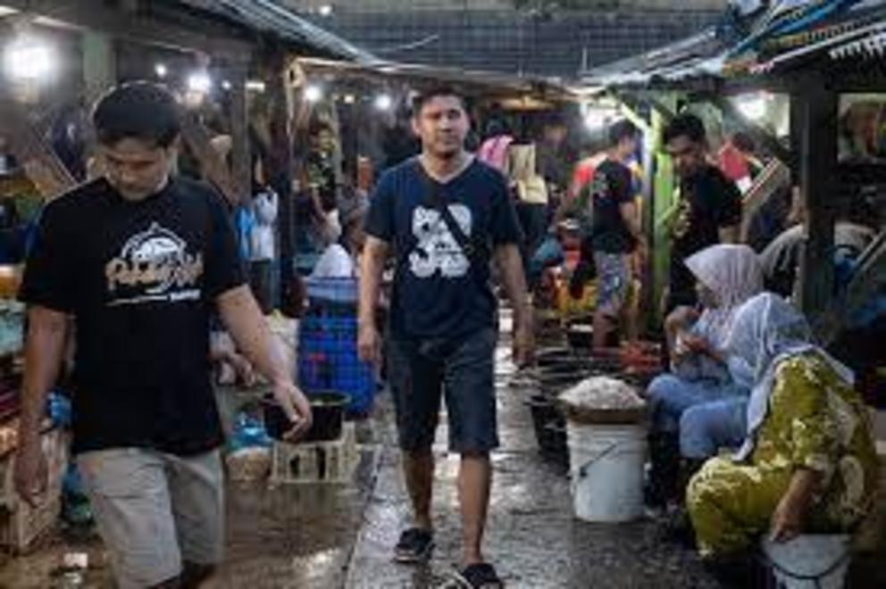 Adhi Tayuh Braka walks through a fish market in Semarang, Indonesia, in September, nearly a year removed from working for DOF.