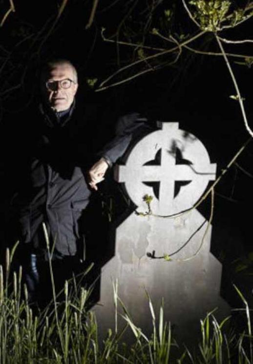  Charles Christian standing by a tombstone posing for press photographs ahead of the ‘werewolf hunt’. Saint Mary’s graveyard, Hull.