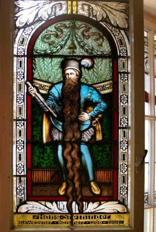 A stained glass window of Hans Staininger in the Church of St. Stephan in Braunau am Inn. Staininger’s strange death was caused by tripping over his own long beard