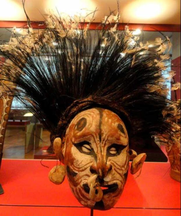 Mask made of overmodelled skull with cassowary feathers, Papua New Guinea.