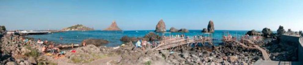 Panorama of the Cyclopean isles in Aci Trezza. With no cyclops in sight, it’s all sun and fun on the coast of Sicily.