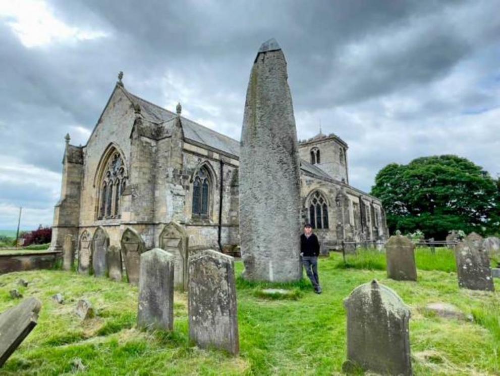 The Rudstone monolith and church. The Rudston Monolith at over 25 feet (7.6 m) is the tallest megalith in the United Kingdom.