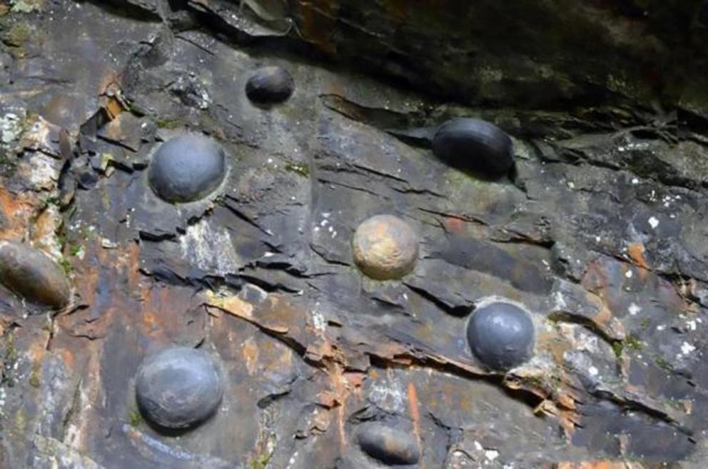 Stone eggs emerging from the Chan Dan Ya cliff.