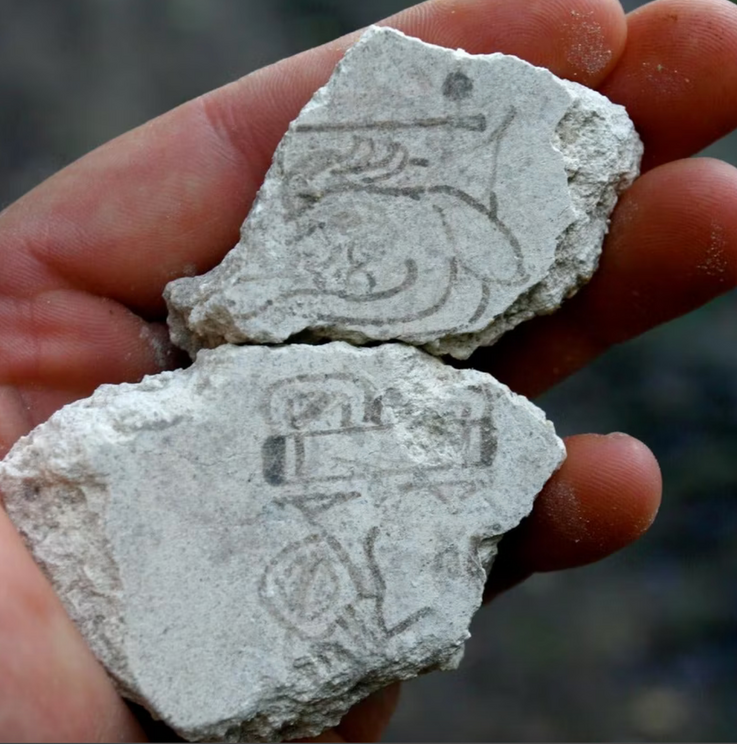 The two fragments depicting a Maya calendar date.