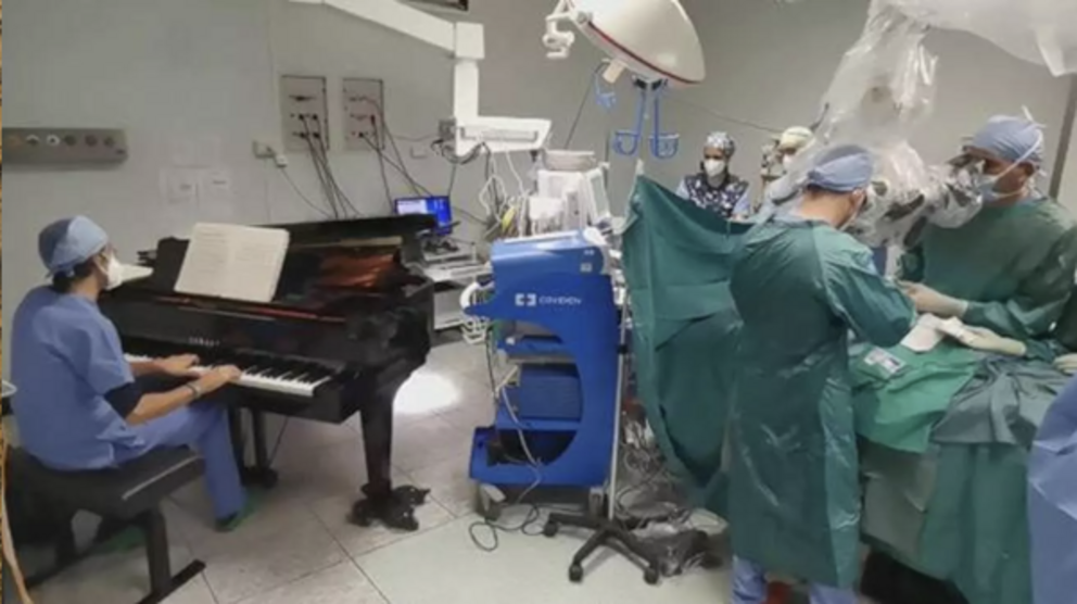 Dr. Emiliano Toso playing piano in an Operating Room, during live neurosurgery