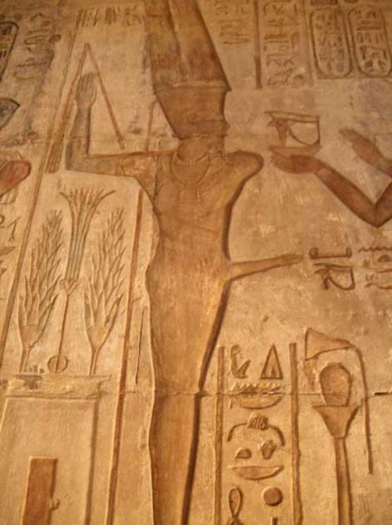 A painted relief depicting the Egyptian god Min at Deir el-Medina.