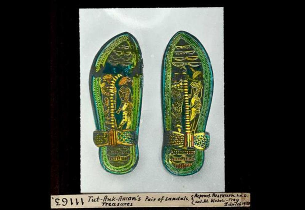 Pair of sandals depicting bound enemies, Nubian and Asiatic, made from wood and overlaid with a marquetry veneer of bark, green leather and gold foil on a stucco base. They were discovered within the tomb of Tutankhamun and are now on display in the Egypt