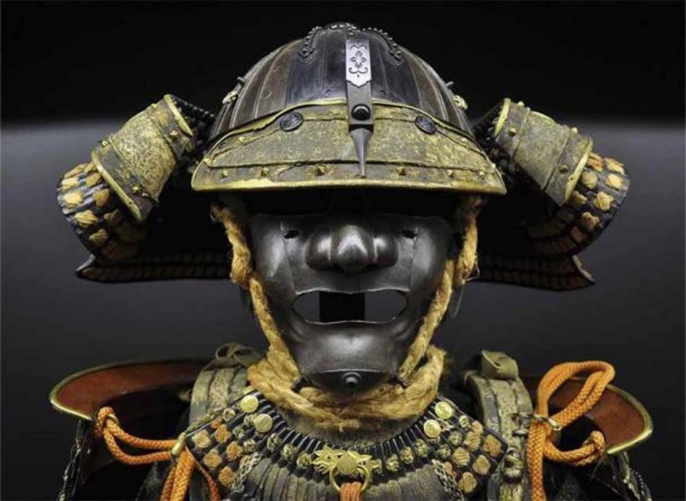 A Japanese Samurai helmet and mask. Samurai helmets were designed to intimidate the enemy. They were shaped to look like devils or mountain sprits. The helmets were constructed in several sections made of metal ornamented with antlers, horns, fur, feather