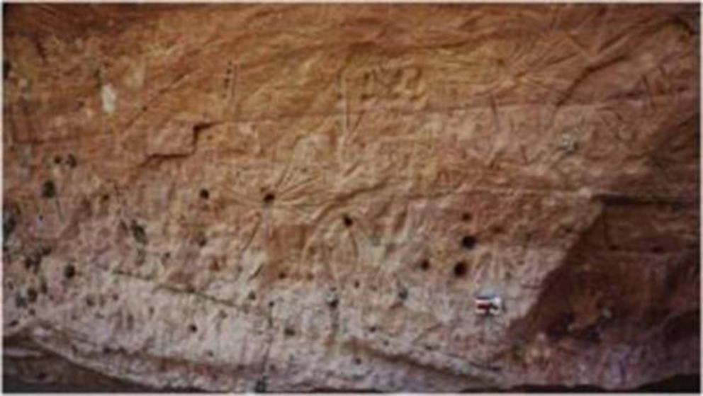 The central Marra Wonga panel featuring seven star-like designs clustered in three rows interpreted by Aboriginal community members as representations of the Seven Sisters.