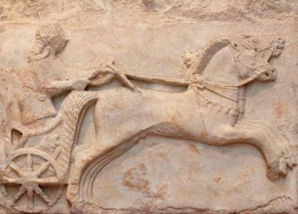 Ancient marble bas-relief of charioteer, with recently invented wheel spokes, late 6th century BC.