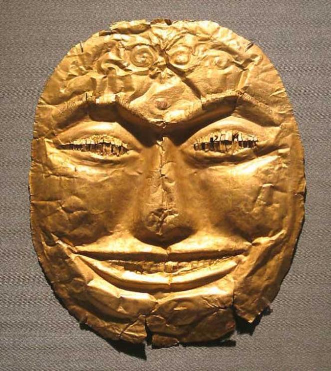 A very happy-looking, gold funerary mask, 14th century, Indonesia