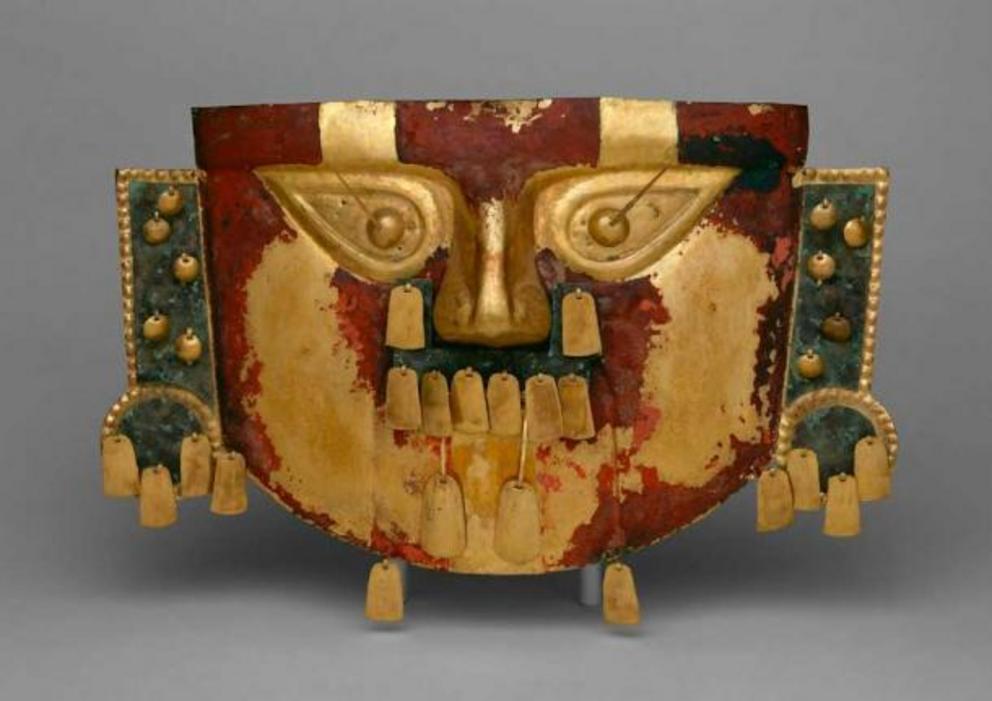 Funerary Mask, 10th–12th century, Lambayeque (Sicán) culture, Peru. This mask, made of hammered sheet gold alloy and covered in red pigment, once adorned the body of a deceased ruler on Peru’s north coast.
