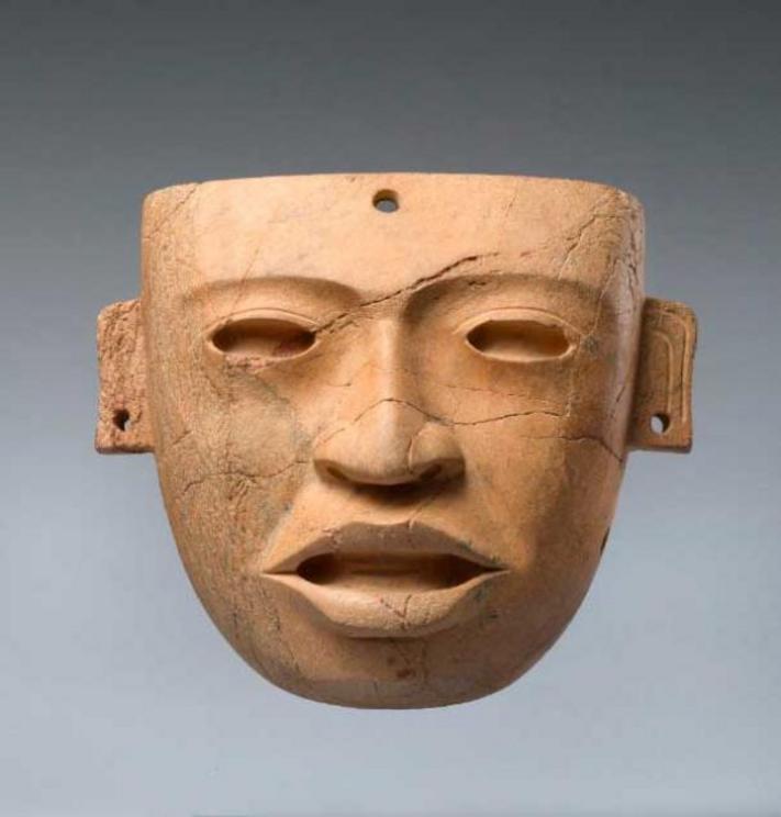 Stone pre-Columbian funerary mask, 250 – 450 AD, Teotihuacan, Mexico. The mask would have been placed over the face of a deceased, elite individual and attached with string through the holes in the ears. 