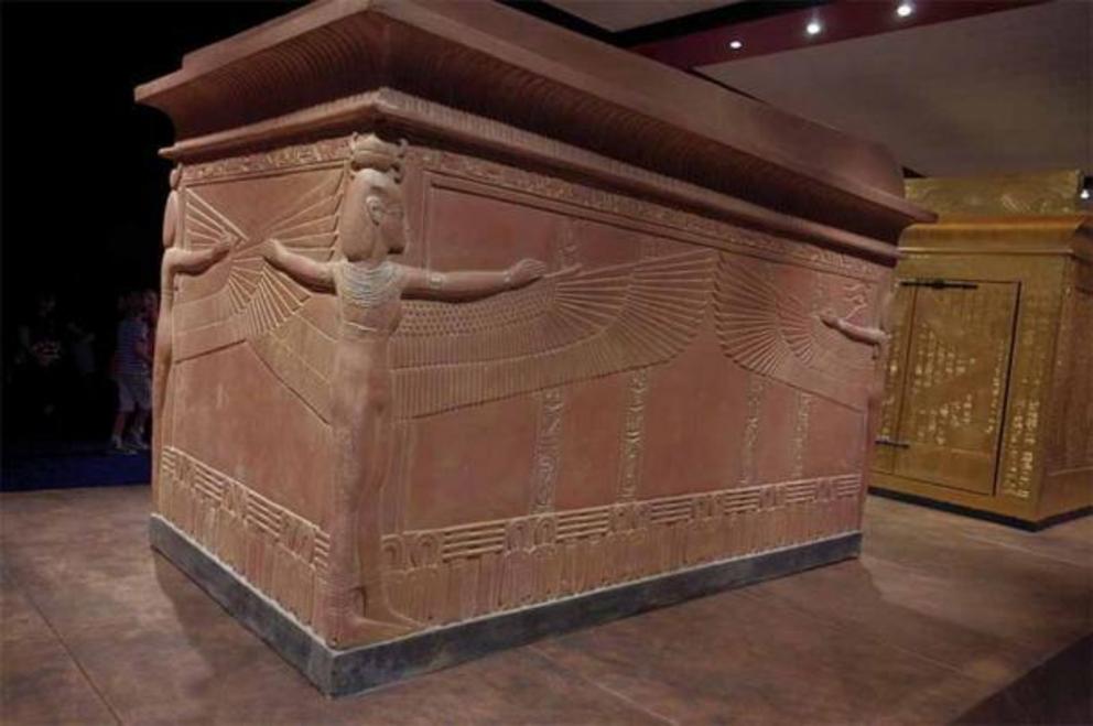 Quartzite Sarcophagus of Tutankhamun, contained three coffins nested within each other. The lower body of the sarcophagus is made of brown quartzite and the lid is made of pink granite tinted to the color of the box. On the sarcophagus are the figures of 