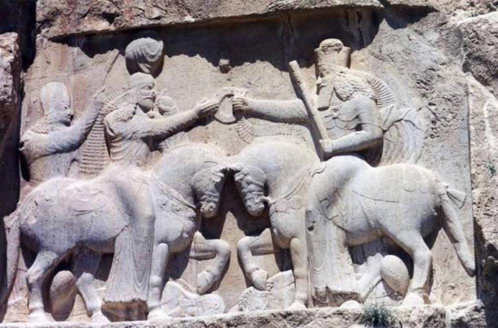 A Sassanian Frieze in Iran showing Persian King Ardashir I crowned by Ahura Mazda (right). The figure standing behind the king is probably his son and successor Shapur I