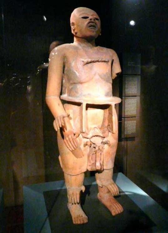 Statue of Xipe Totec, the flayed-skin god.  Xipe Totec is represented wearing flayed human skin, usually with the skin of the hands falling loose from the wrists. At the annual festival of Xipe Totec slaves or captives were sacrificed and priests wore the