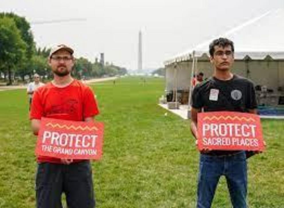 People call for the protection of sacred Indigenous spaces to commemorate the delivery of a totem pole carved by the Lummi Nation as a gift to President Joe Biden on July 29, 2021, in Washington, D.C.