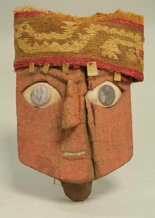 An almost cartoon-like funerary mask made with wood, gold, cloth and shell, 13th–15th century AD, Ica, Peru