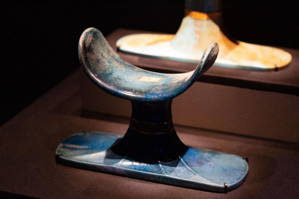 A headrest crafted from faience, or glazed ceramic.