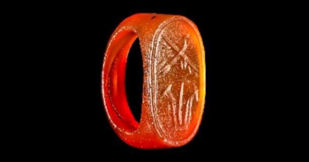 An amber ring engraved with hieroglyphs, possibly New Kingdom