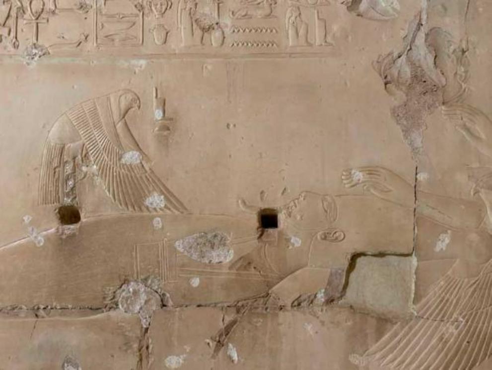 Detail of Osiris from the Temple of Seti I at Abydos. Isis lands on his penis in the form of a bird, to impregnate herself with Horus. According to the myth, the reassembled and resurrected body of Osiris only had thirteen original pieces, because the fou