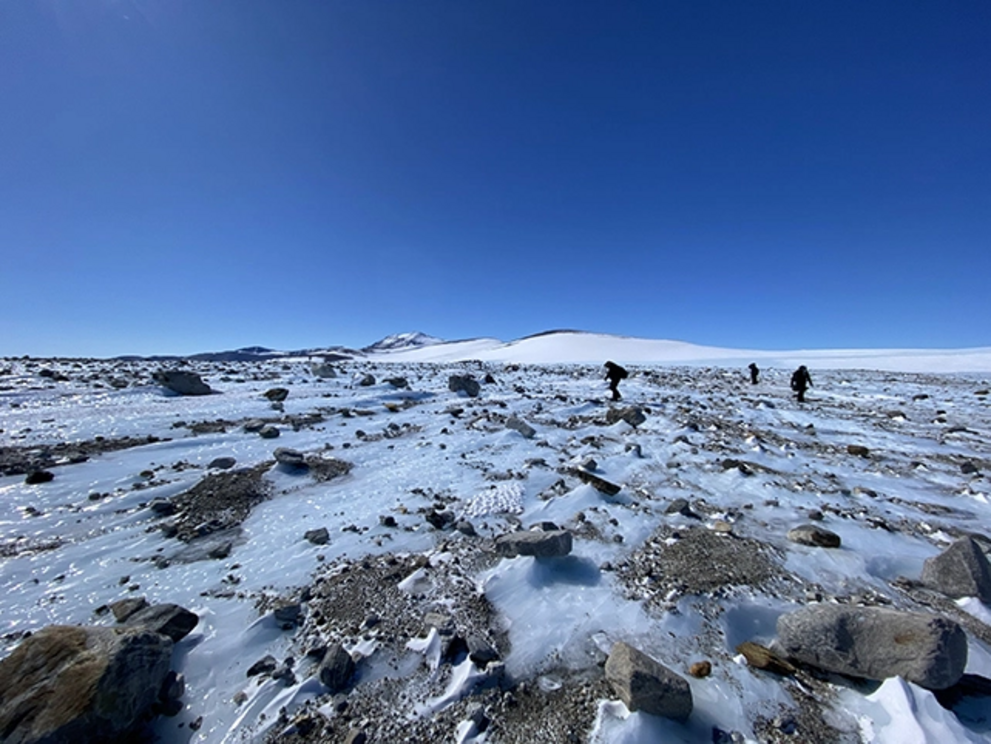 The researchers at work on an ice field.