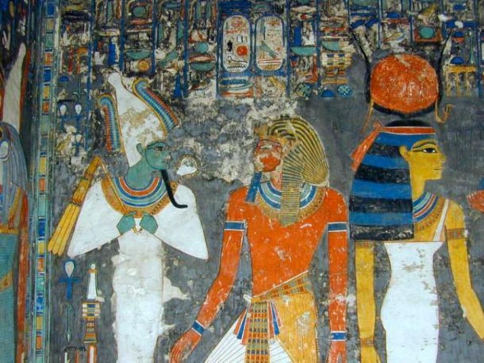 Mural from the tomb of Horemheb, featuring Horemheb between Osiris (left) bearing the royal whip and scepter and Hathor (right) Mistress of the West, of Heaven and of all the Gods