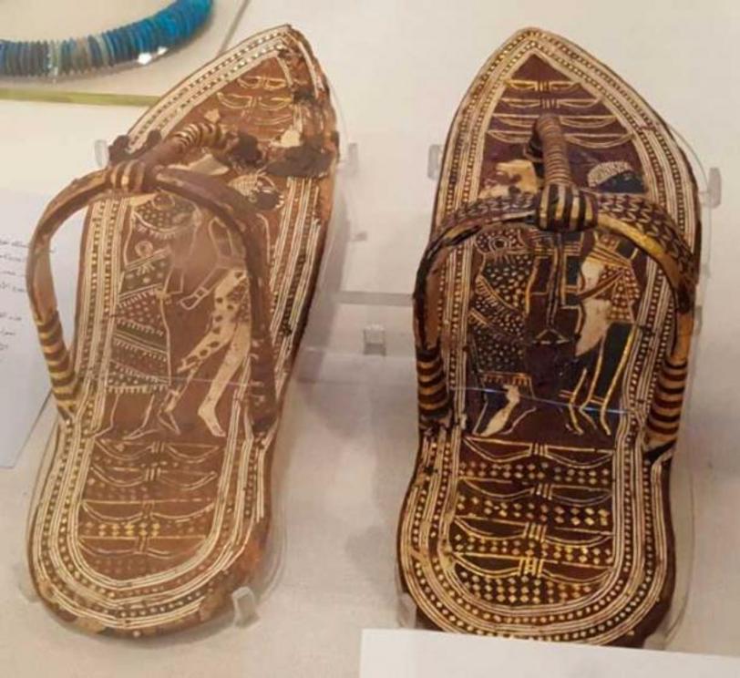 Sandals of Tutankhamun, showing foreigners alongside eight bows, with the ninth bow being represented by the sandal strap itself. Thus, the king walked on eighteen symbolic enemies. Now in the Egyptian Museum, Cairo.