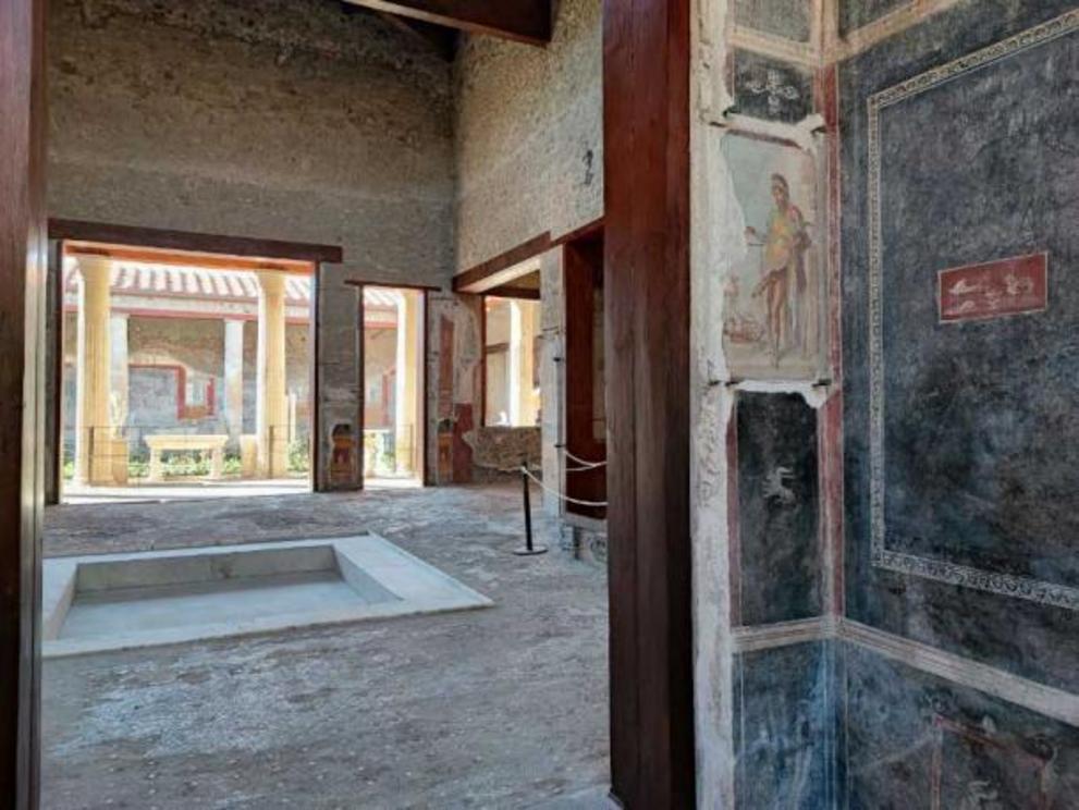 View of the courtyard from a small room by the kitchen, part of a brothel area, indicated by erotic art, shown here a fresco of Priapus.