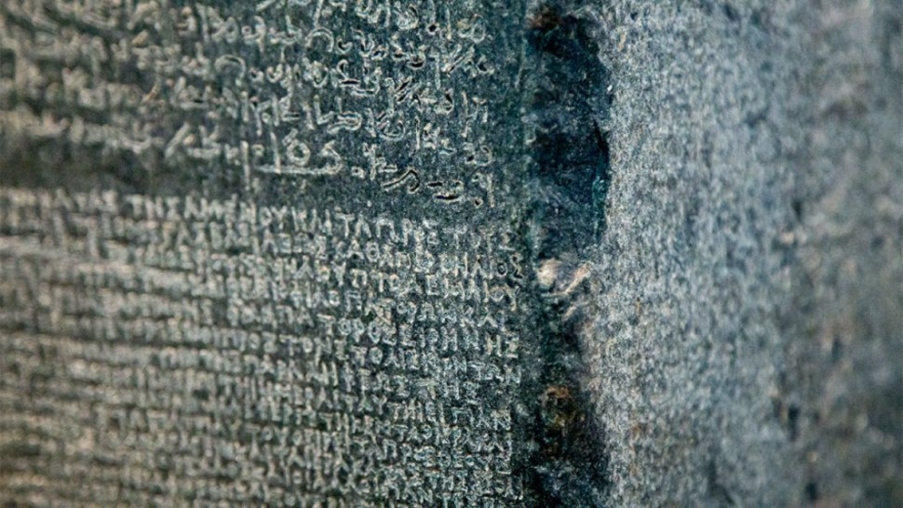 A close up the Rosetta Stone, which includes three written languages: ancient Greek, Egyptian hieroglyphics and demotic.