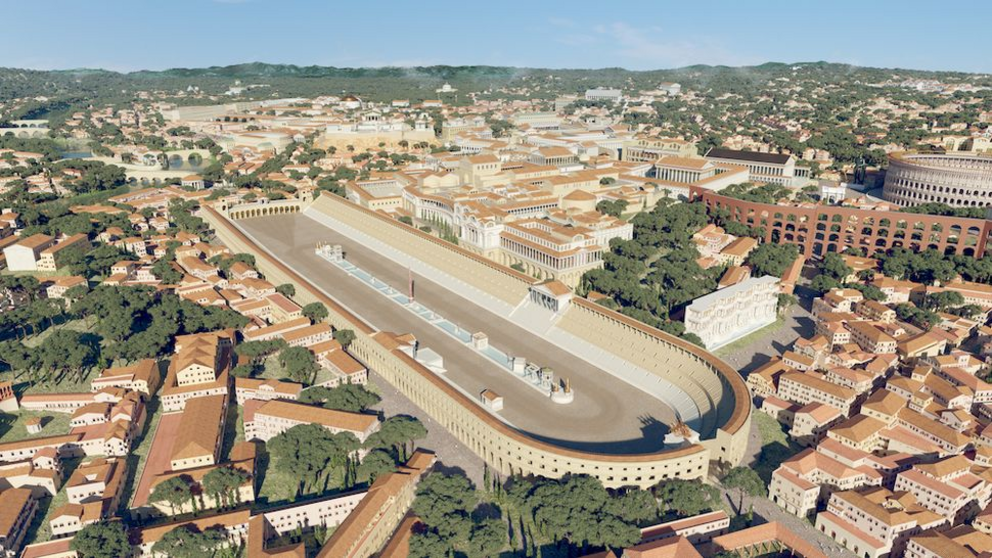 An aerial view of the city from the southeast. In the foreground are the Baths of Caracalla. In the middle ground is the Circus Maximus racetrack and the Colosseum (to the right). In the distance is the Tiber River.