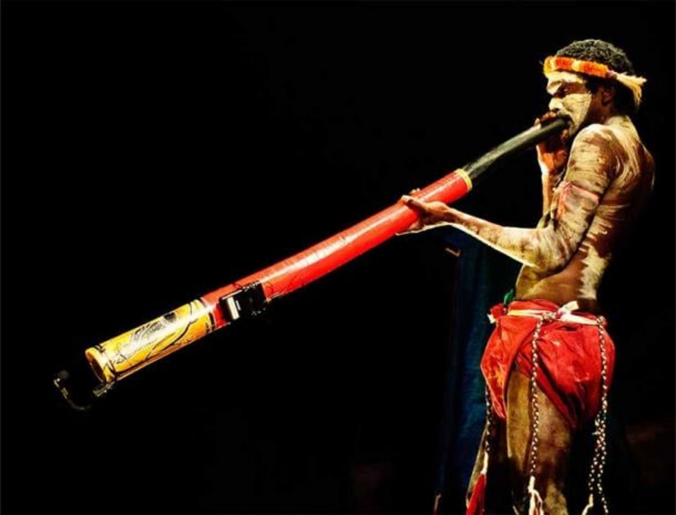 Representational image of a man playing a didgeridoo.