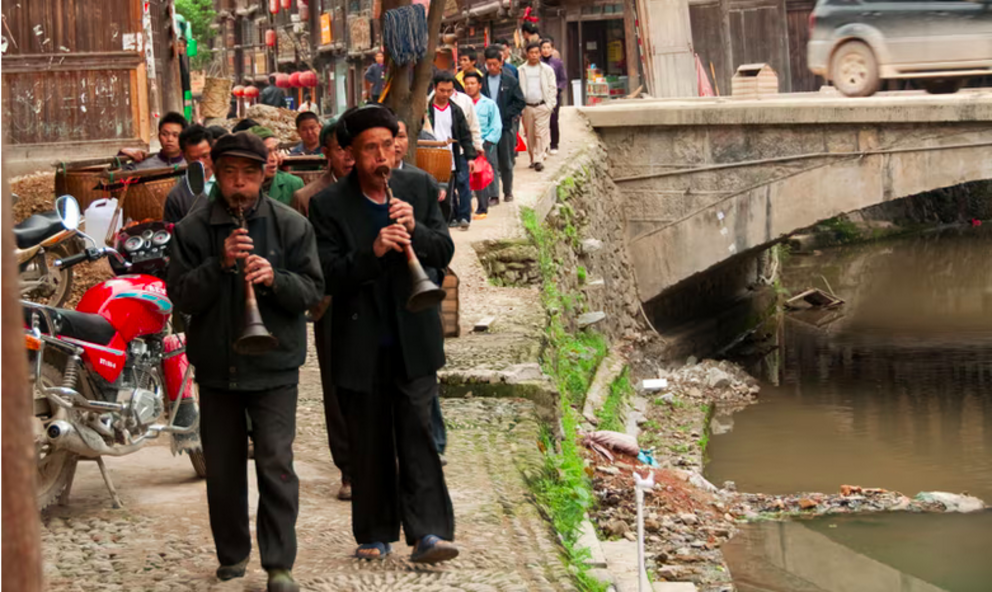 A funeral procession in a village in Guizhou province. Photograph: Roberto Cornacchia/Alamy