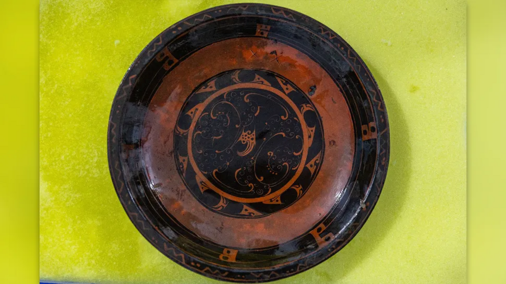 The hundreds of artifacts buried in the tomb include ornate objects of pottery, copper, bronze, wood, bamboo and lacquerware, such as this plate.