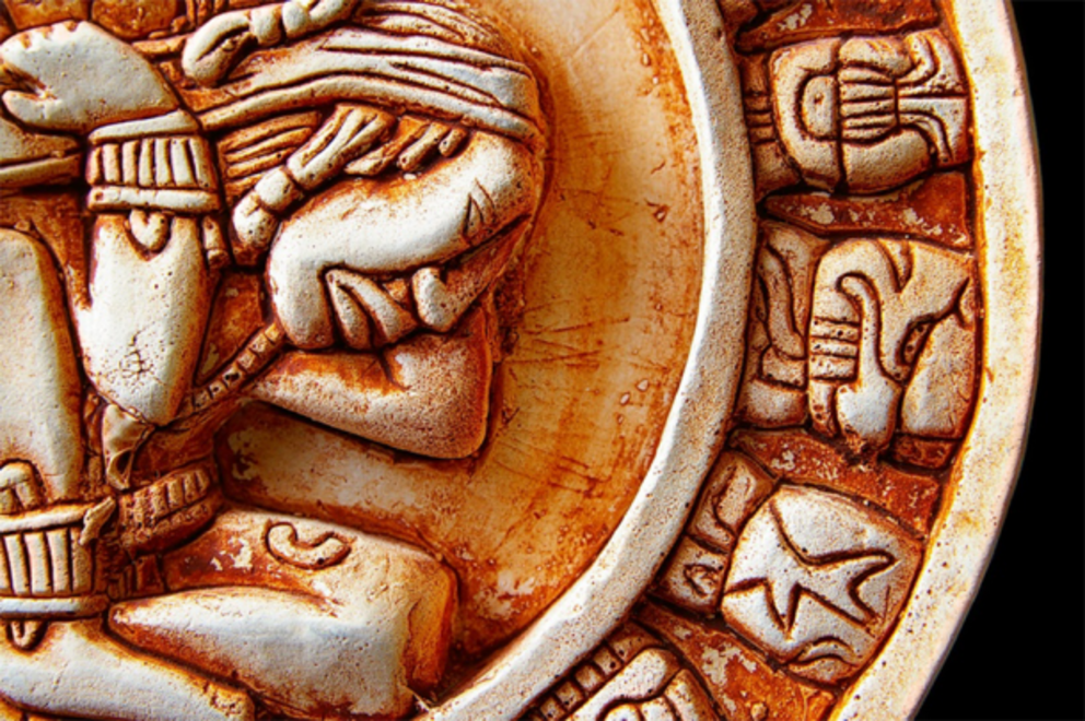 Close-up of glyphs on a Mayan calendar.