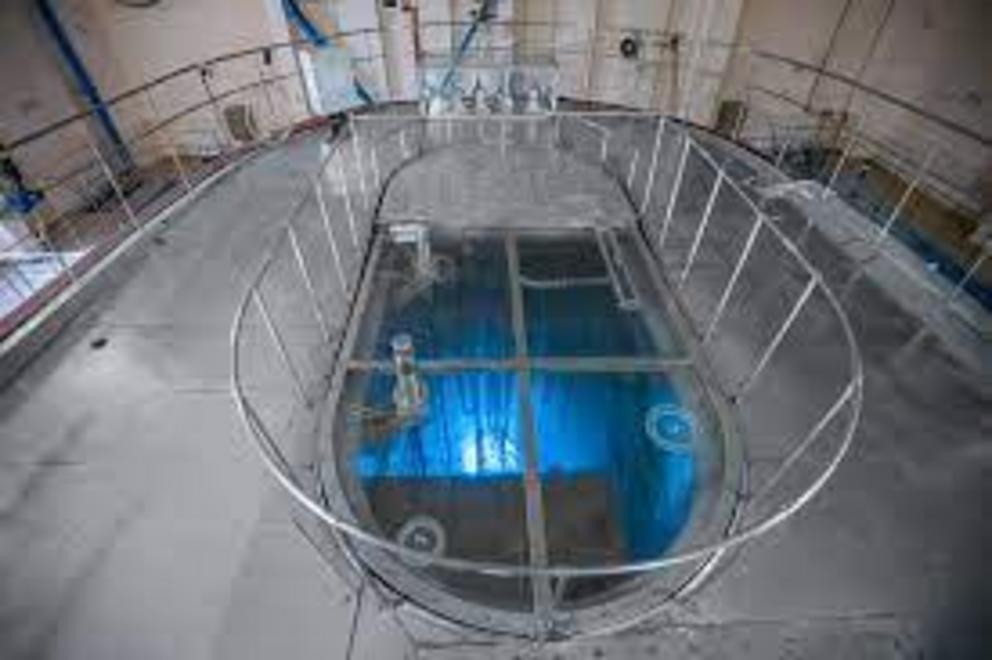 The blue glow seen in the water cooling the core of a nuclear reactor is known as Cherenkov radiation.