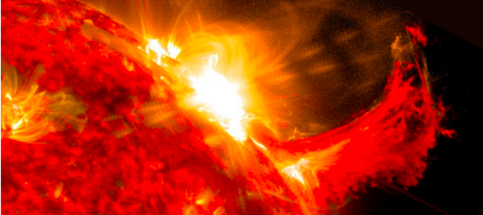 A solar flare and a burst of solar material erupting out into space. (NASA/SDO)