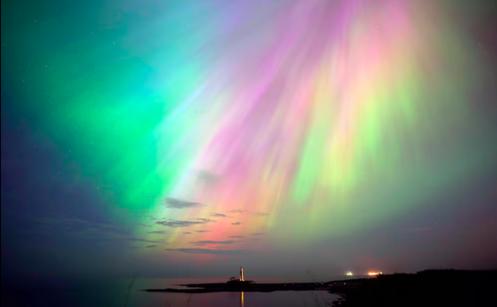 The aurora borealis, known as the Northern Lights, shine over St Mary's Lighthouse in Whitley Bay, Tyne and Wear, northern England, on Friday May 10. PA 