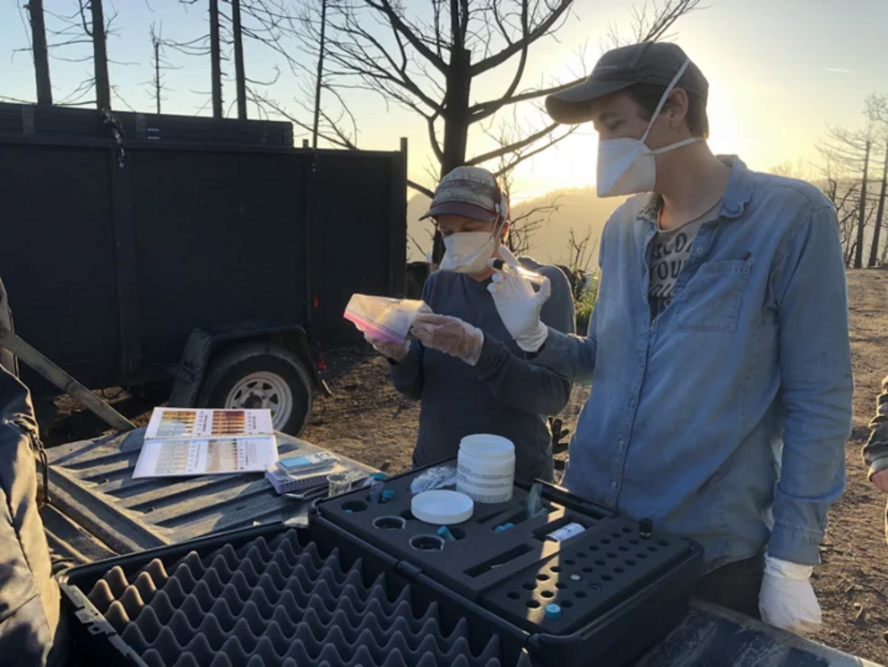 Maya Elson, a mycologist at CoRenewal, and colleague testing soil for petroleum. 