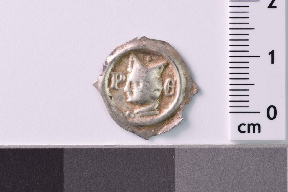 A close-up of one of the silver coins that archaeologists discovered in Glottertal, Germany.