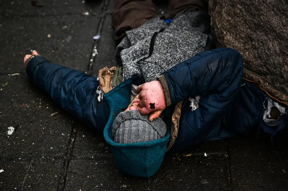 A person lies on the street after the decriminalization of all drugs, in the Old Town Chinatown neighborhood in Portland, Ore., on Jan. 25, 2024. (Bottom Left) A used Narcan brand naloxone nasal spray lies on the street after paramedics and police respond