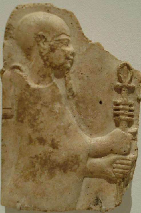 Stucco relief of Ptah holding a staff that bears the combined ankh and djed symbols. Late Period or Ptolemaic Dynasty, 4th to 3rd century BC.