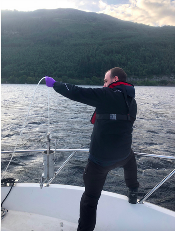 Gert-Jan Jeunen prepares to lower a sampling container into the water. | Photo by Neil Gemmell