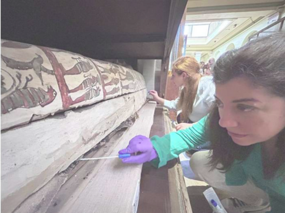 In this undated photo provided by Abdelrazek Elnaggar, Emma Paolin, PhD researcher at University of Ljubljana, background and Dr. Cecilia Bembibre, lecturer at the University College London take swab samples for the purpose of microbiological analysis at 